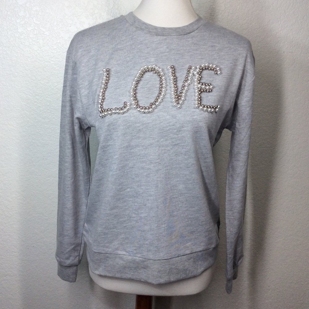 Free Generation Gray sweatshirt with white pearls spelling out the word "LOVE"